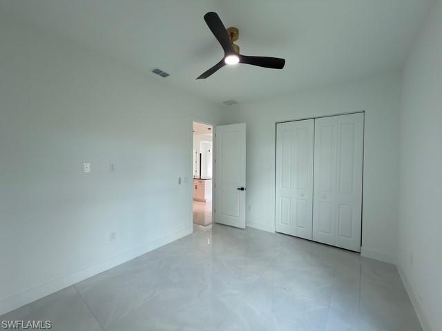 Unfurnished bedroom featuring a closet and ceiling fan