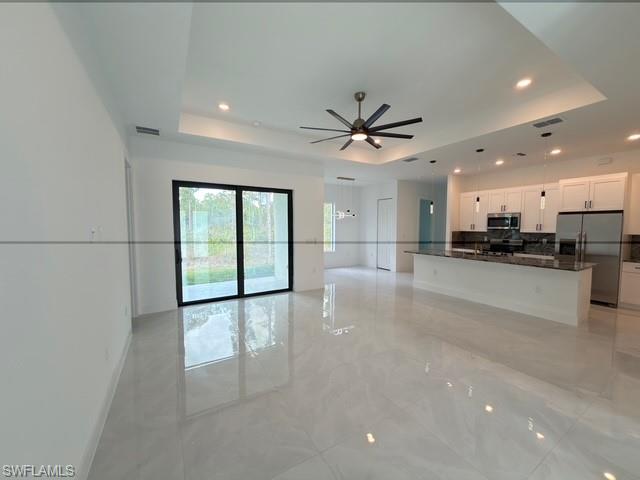 Unfurnished dining area with light tile patterned floors and baseboards