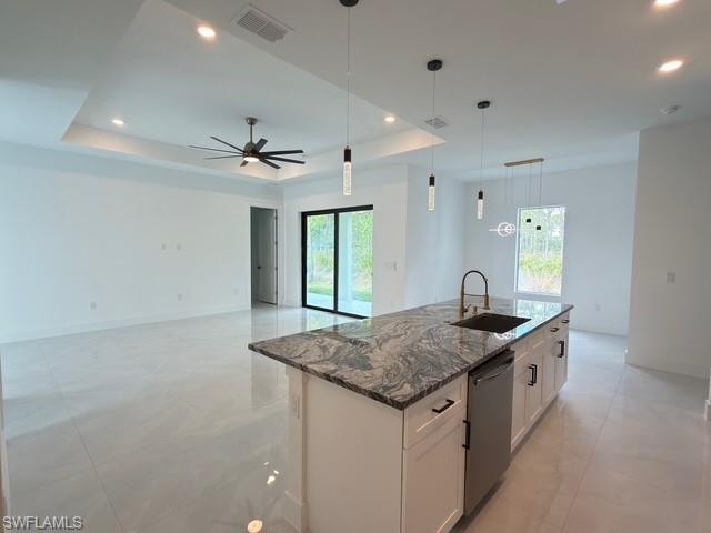 Kitchen featuring hanging light fixtures, dark stone countertops, appliances with stainless steel finishes, tasteful backsplash, and recessed lighting