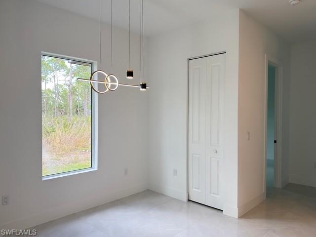 Spare room featuring baseboards