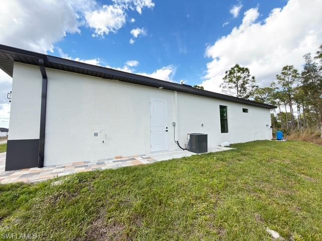 Back of property with stucco siding and a patio area