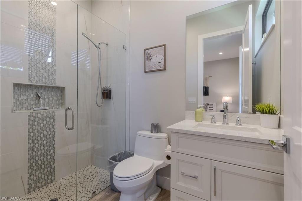 Full bath featuring vanity and a shower stall