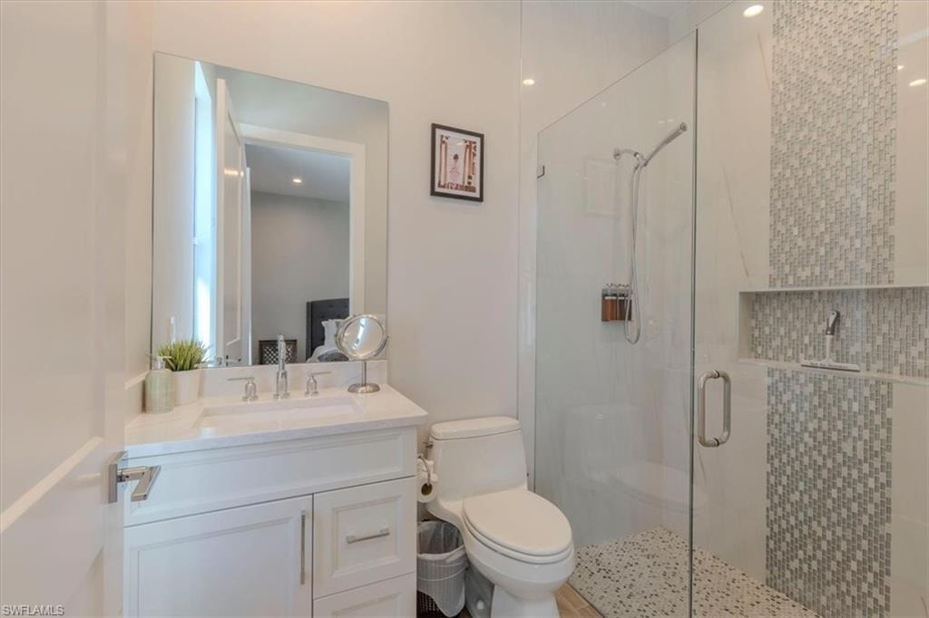 Full bath with vanity and a stall shower