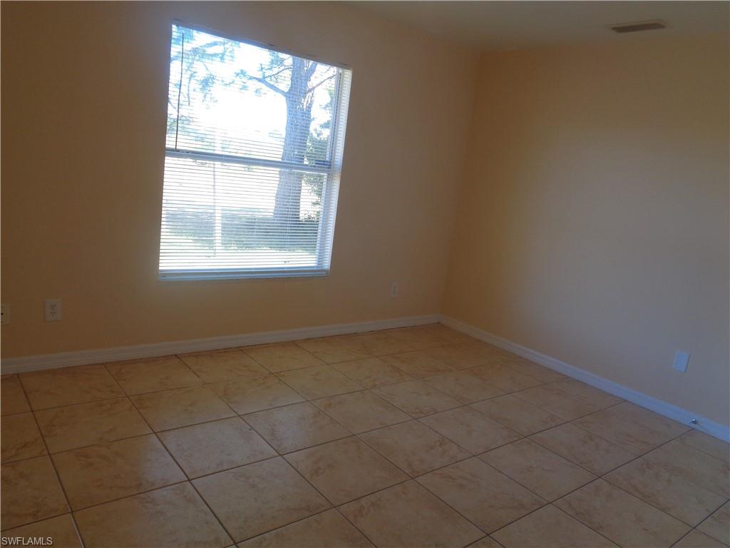 Guest bedroom 2 featuring light tile patterned floors