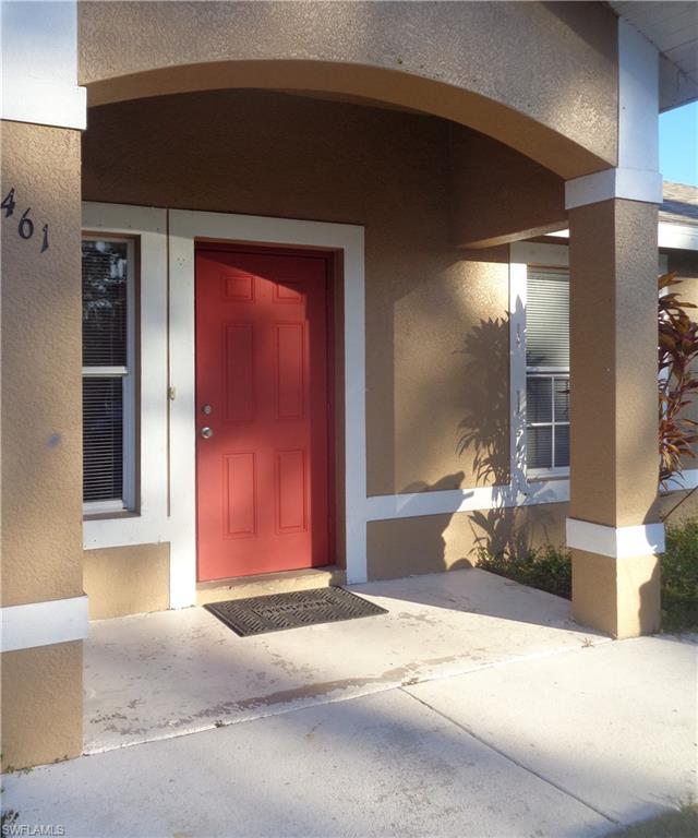 Doorway to property featuring porch stucco siding