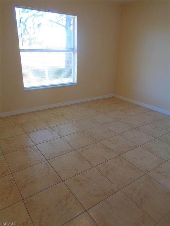 Guest bedroom 2 featuring light tile patterned floors