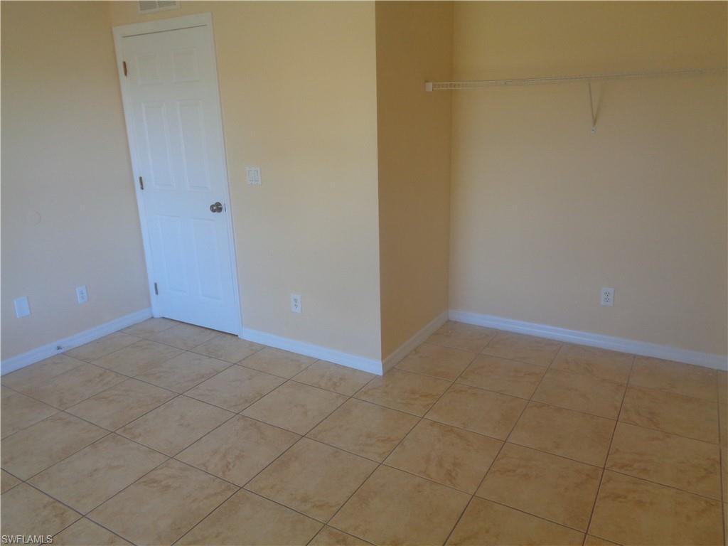 Guest bedroom 2 featuring light tile patterned floors