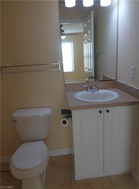 Master bedroom's bathroom featuring vanity and toilet and light tile patterned flooring