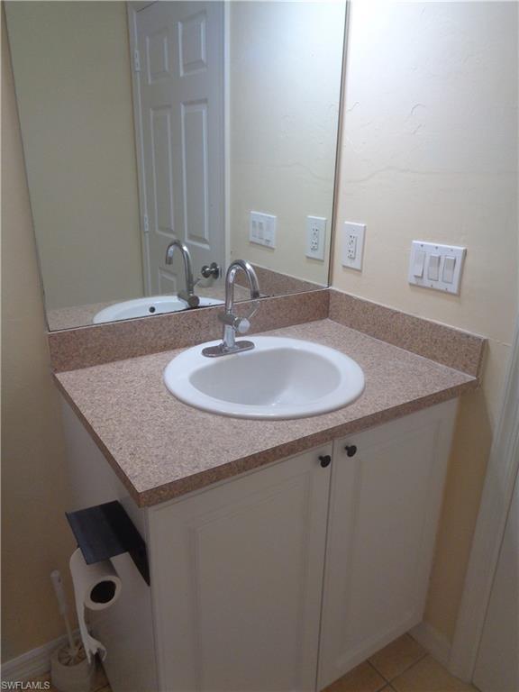 Guest bathroom featuring vanity and light tile patterned flooring