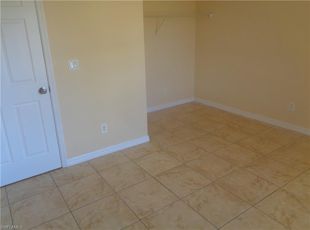 Guest bedroom 2 featuring light tile patterned floors
