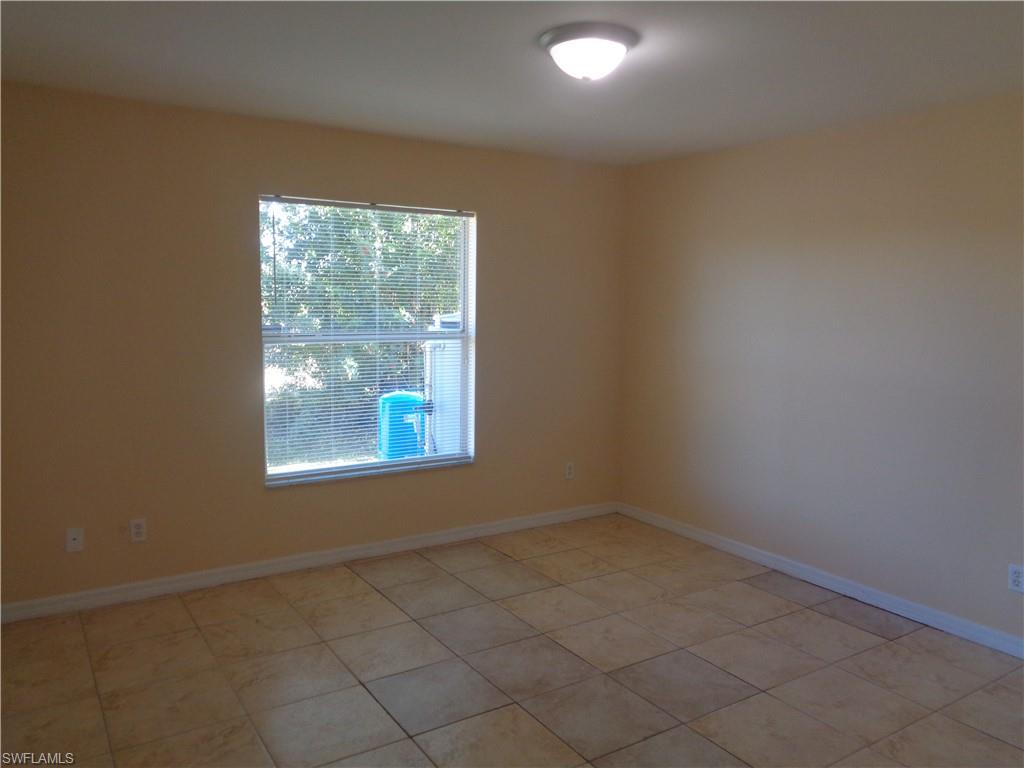 Guest bedroom 1 featuring light tile patterned flooring