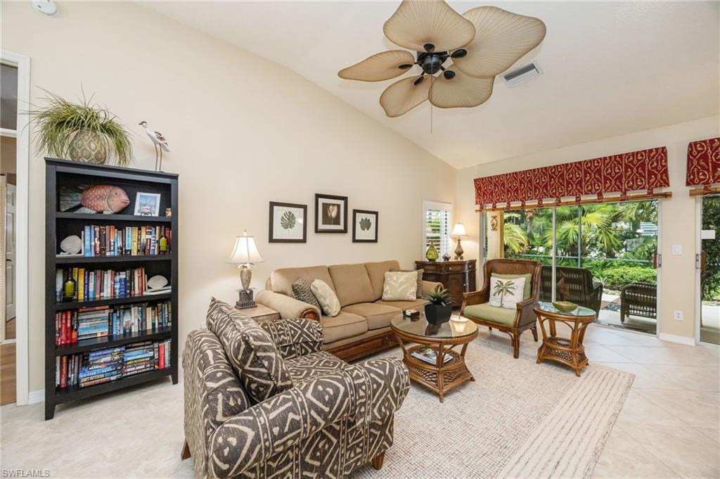 Living room featuring baseboards and high vaulted ceiling, couch can be made into a queen sized bed