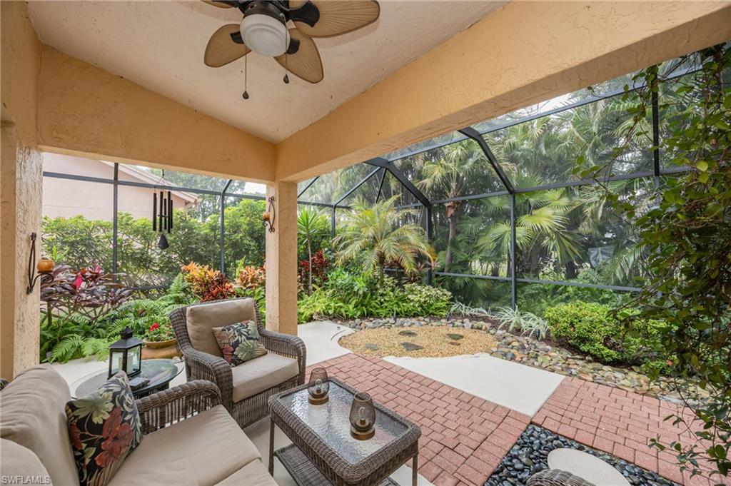 Screened in lanai, featuring lofted ceiling, outdoor lounge area, and a ceiling fan