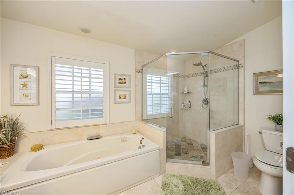 Bathroom with a bath, a shower stall, and tile patterned floors