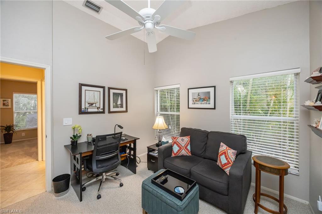 Office featuring carpet, high vaulted ceiling, and ceiling fan, couch can be made into a single sized bed