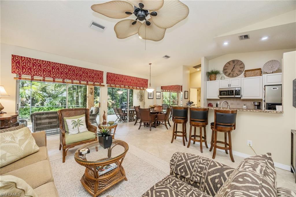 Living area featuring high vaulted ceiling, a ceiling fan, light tile patterned flooring, and recessed lighting, couch can be made into a queen sized bed
