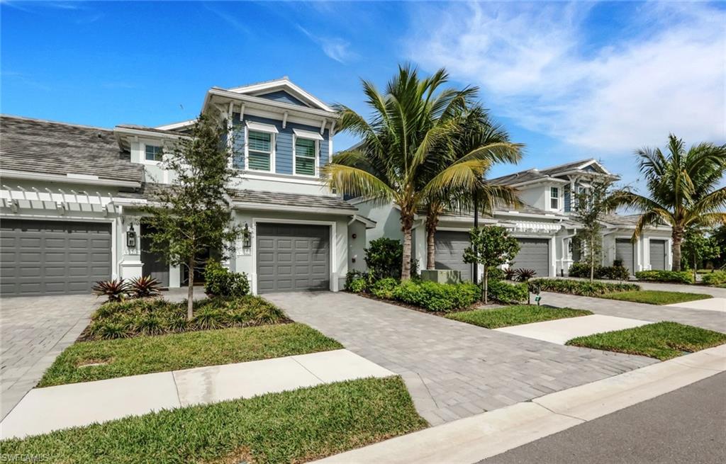 View of front of home with driveway and a garage