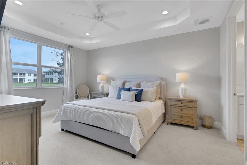 Bedroom featuring recessed lighting, a ceiling fan, light carpet, and a raised ceiling
