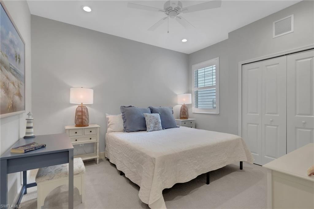 Bedroom with light carpet, recessed lighting, a closet, and ceiling fan