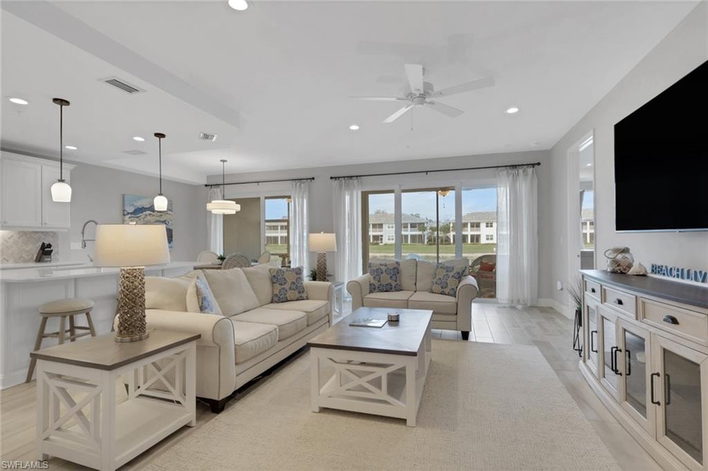 Living area with a ceiling fan and recessed lighting
