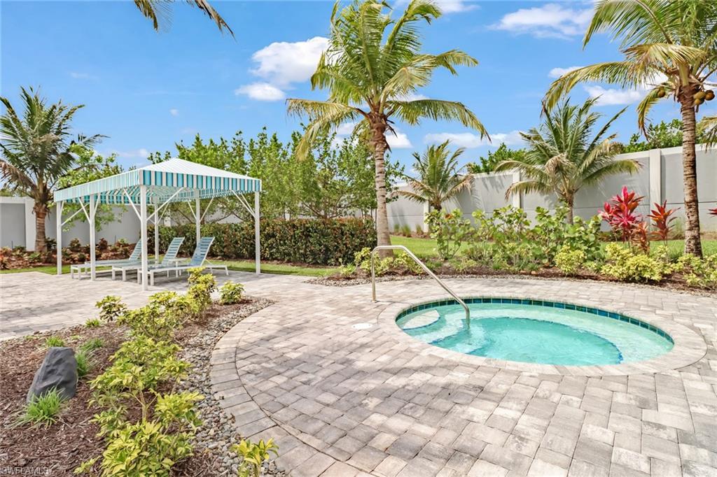 View of swimming pool featuring a fenced backyard, a patio area, and an in-ground hot tub