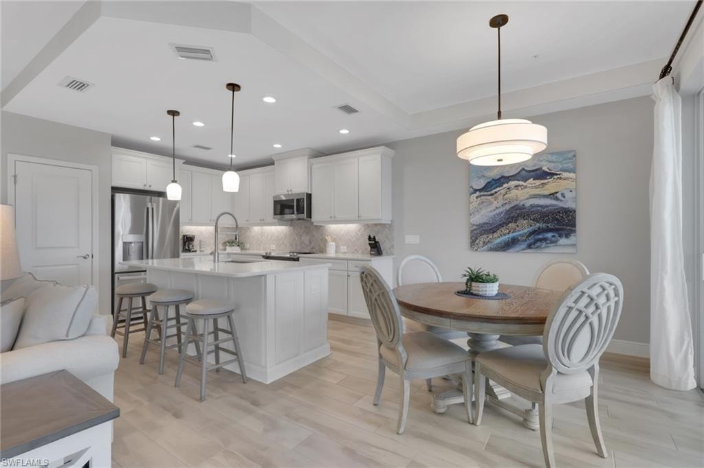 Dining area featuring light wood-style floors and recessed lighting
