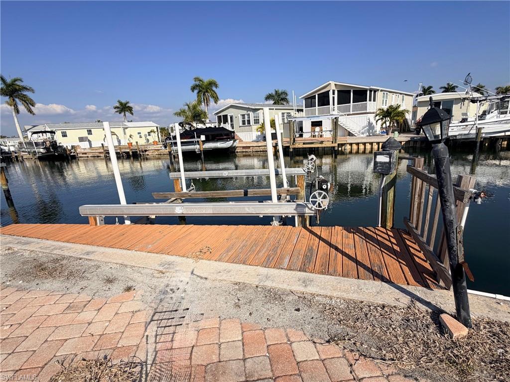 Dock area with a water view and boat lift