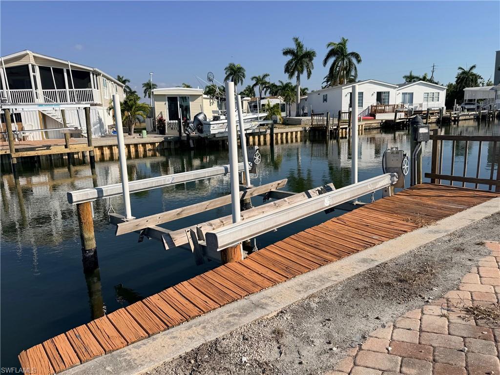 Existing Dock area featuring a water view, boat lift