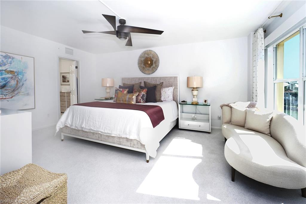 Bedroom featuring carpet floors, a ceiling fan, and ensuite bath