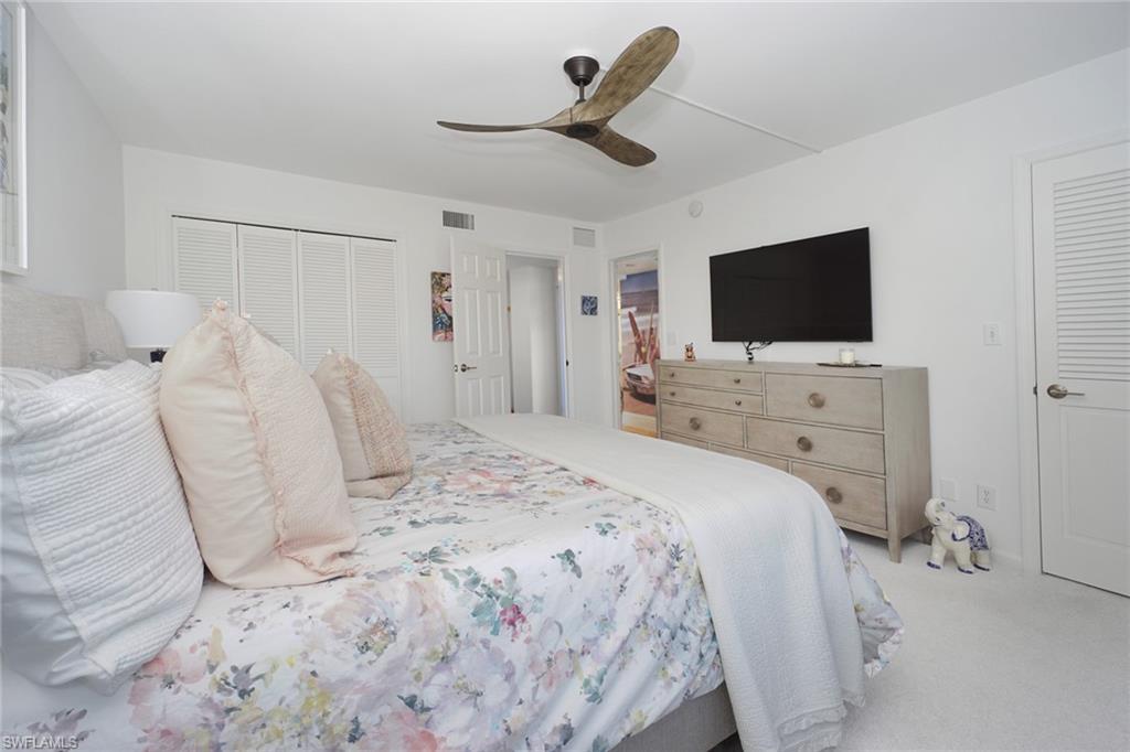 Bedroom with ceiling fan, carpet flooring, and a closet