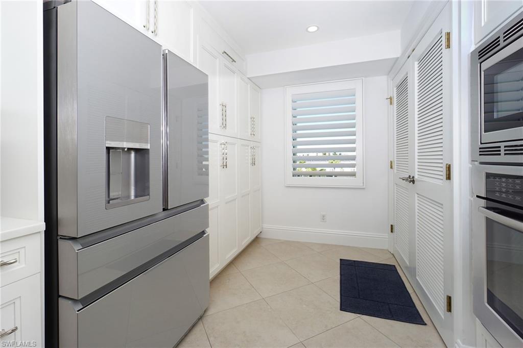 Kitchen featuring white cabinetry, stainless steel appliances, light tile patterned floors, light countertops, and recessed lighting