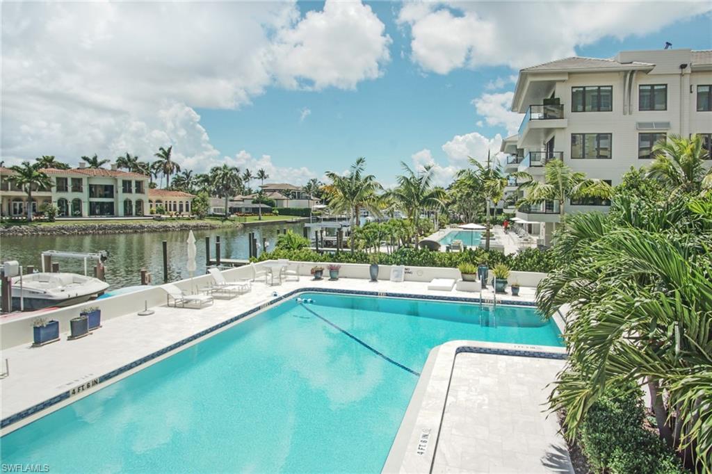Community pool with a patio area and a water view