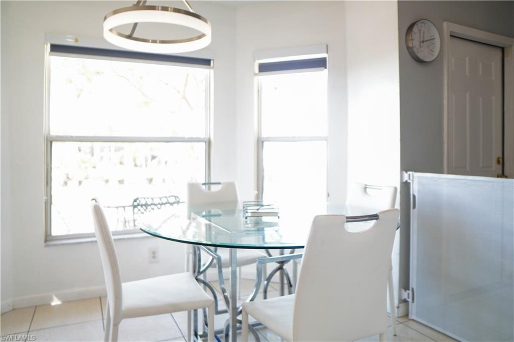 Dining room with light tile patterned flooring and baseboards