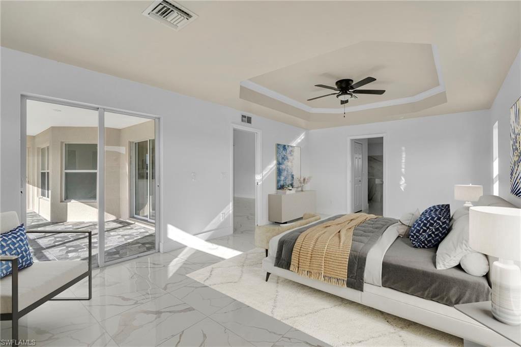 Bedroom with access to outside, a tray ceiling, a ceiling fan, a spacious closet, and marble finish flooring