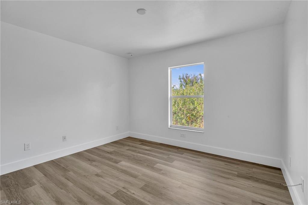 Spare room featuring light wood-style flooring