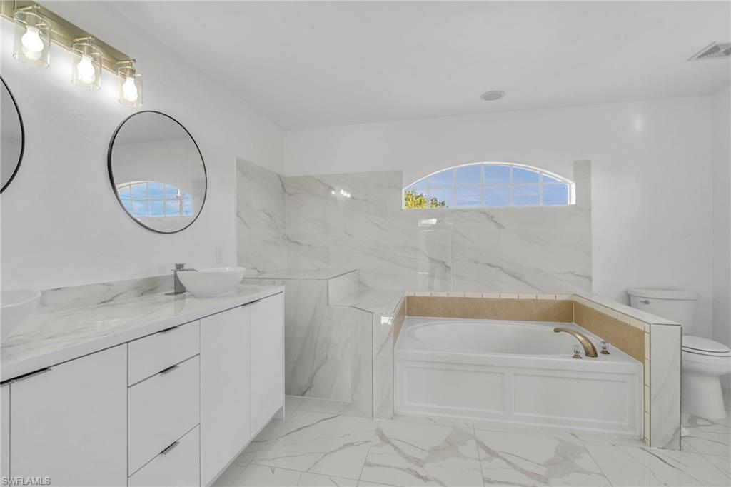 Bathroom with a bath and double vanity