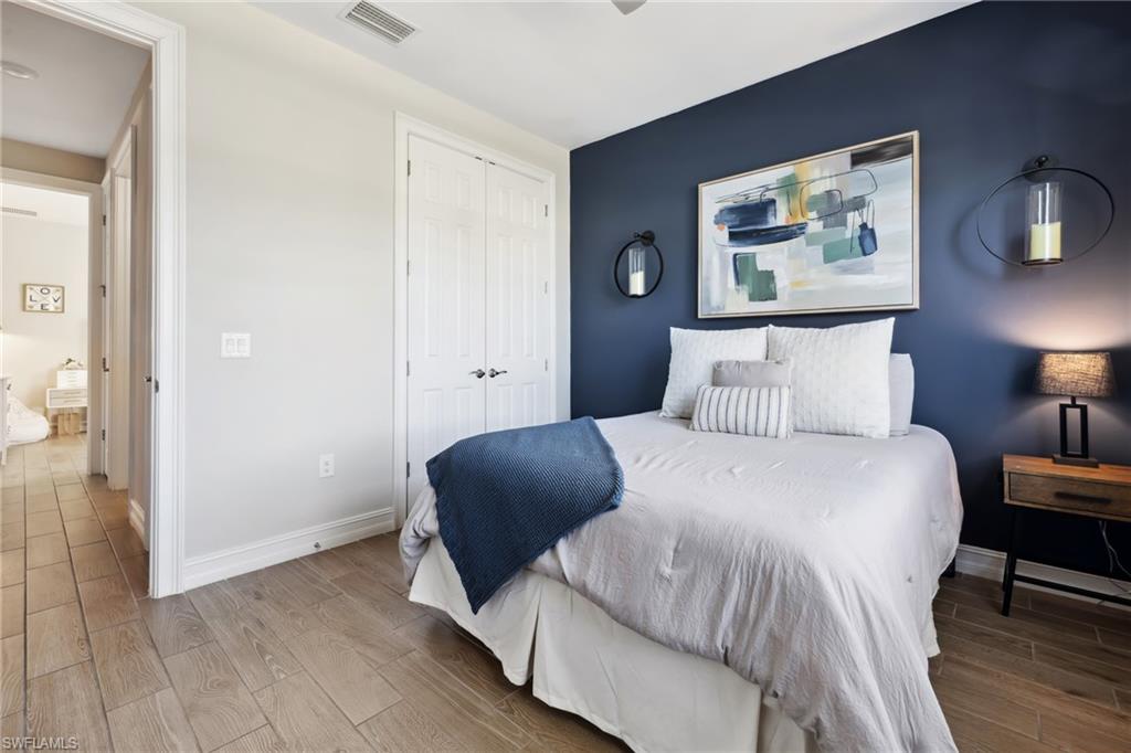 Bedroom with wood finish floors and a closet