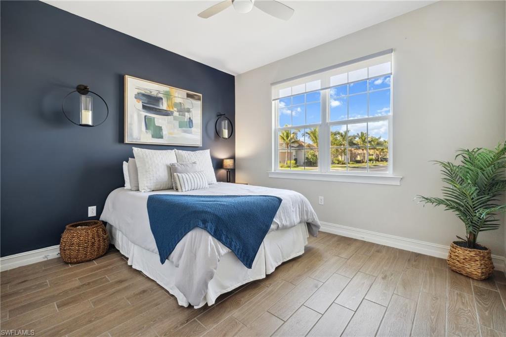 Bedroom with wood tiled floors and ceiling fan