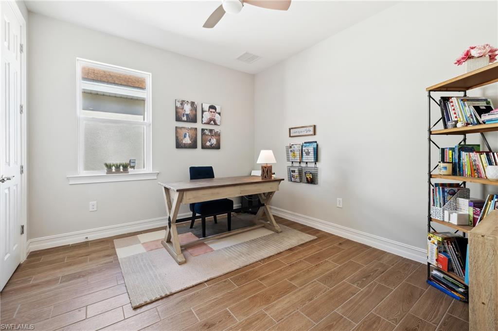Office space featuring wood tiled floors and ceiling fan