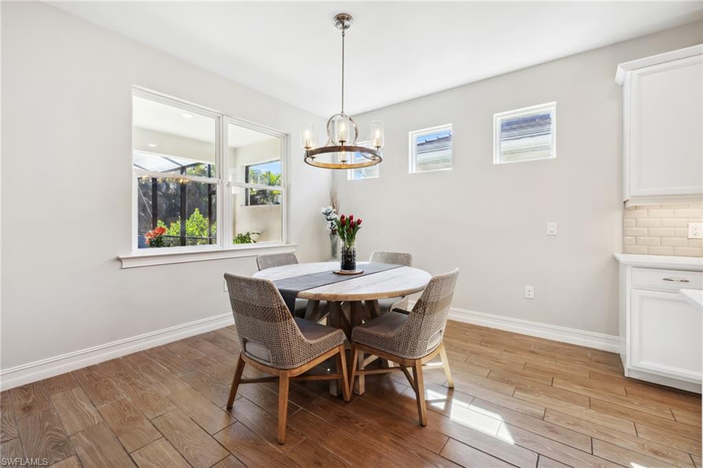 Dining space with light wood-type flooring and a chandelier