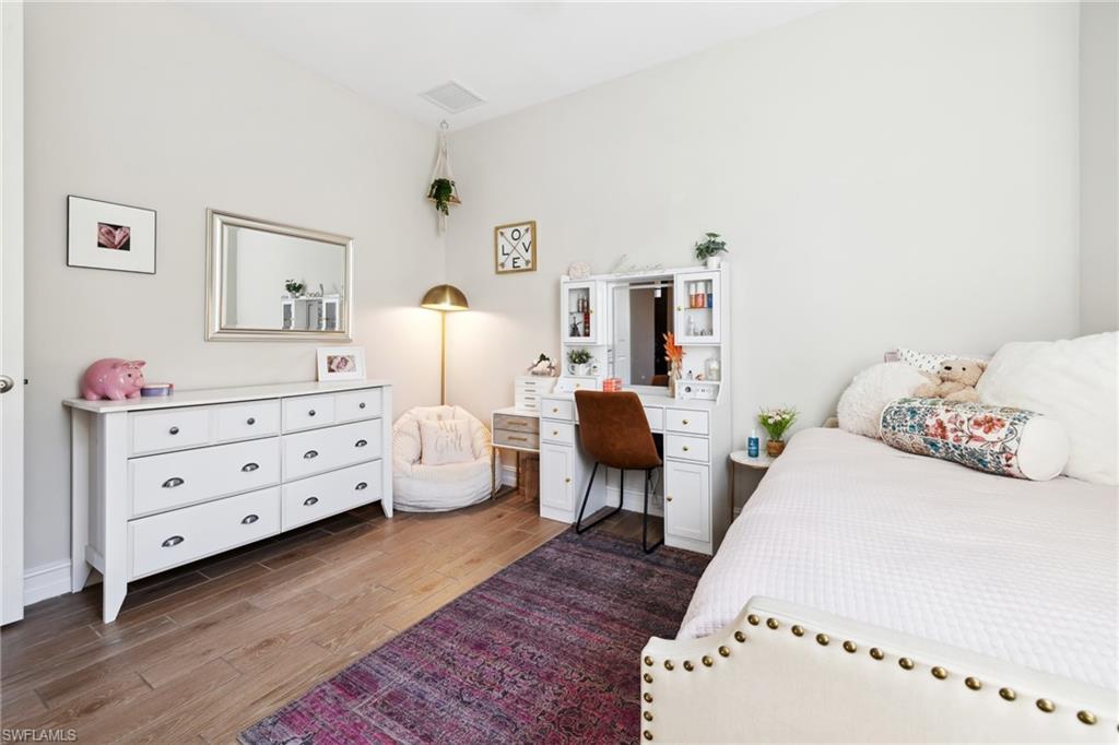Bedroom with dark wood finished floors