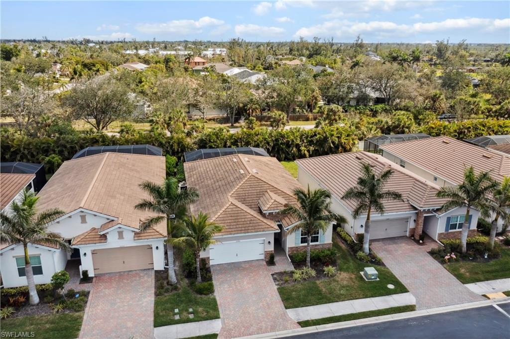 Aerial view of residential area featuring a tree filled landscape