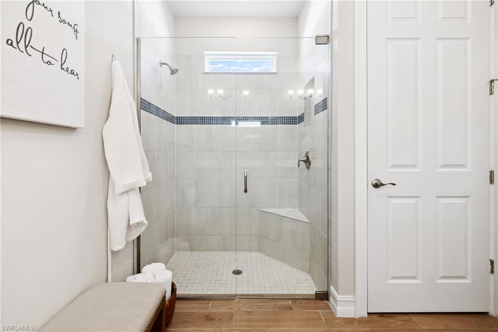 Full bathroom with a stall shower and wood finish floors