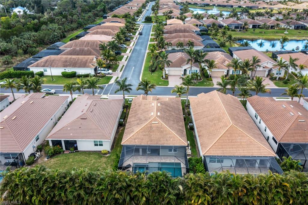 Aerial perspective of suburban area featuring a nearby body of water