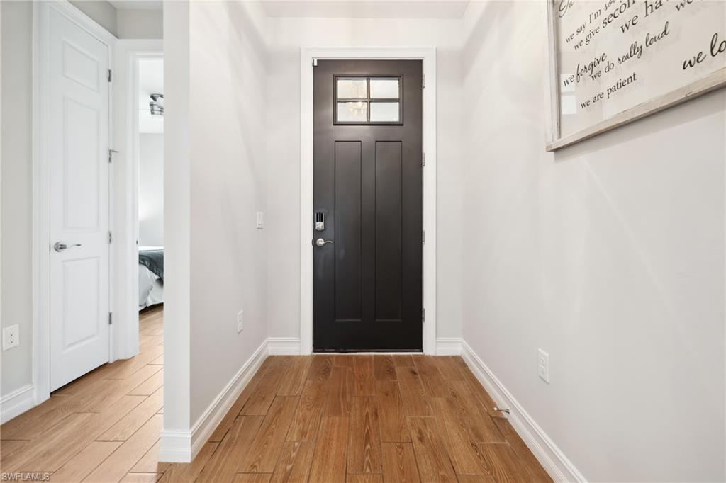 Entrance foyer featuring wood finished floors and baseboards