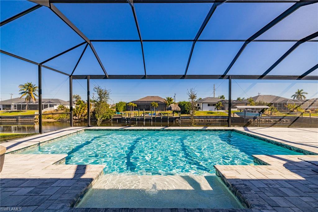 Outdoor pool with a residential view, a sunroom, a lanai, and a patio