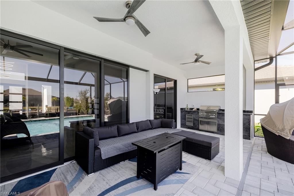 View of patio with ceiling fan, outdoor lounge area, and area for grilling
