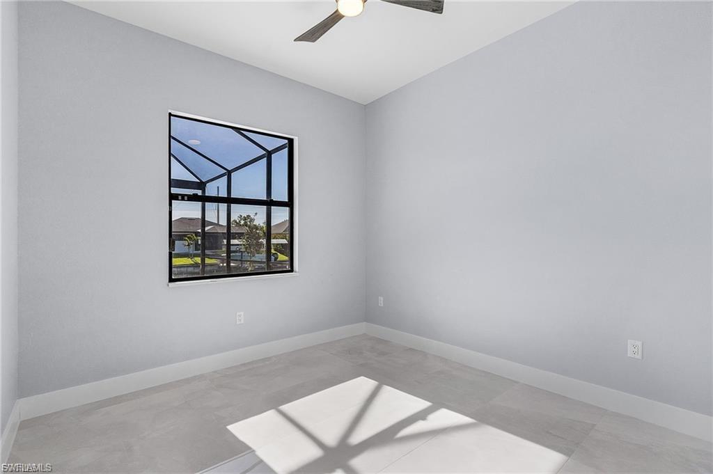 Spare room featuring baseboards and a ceiling fan