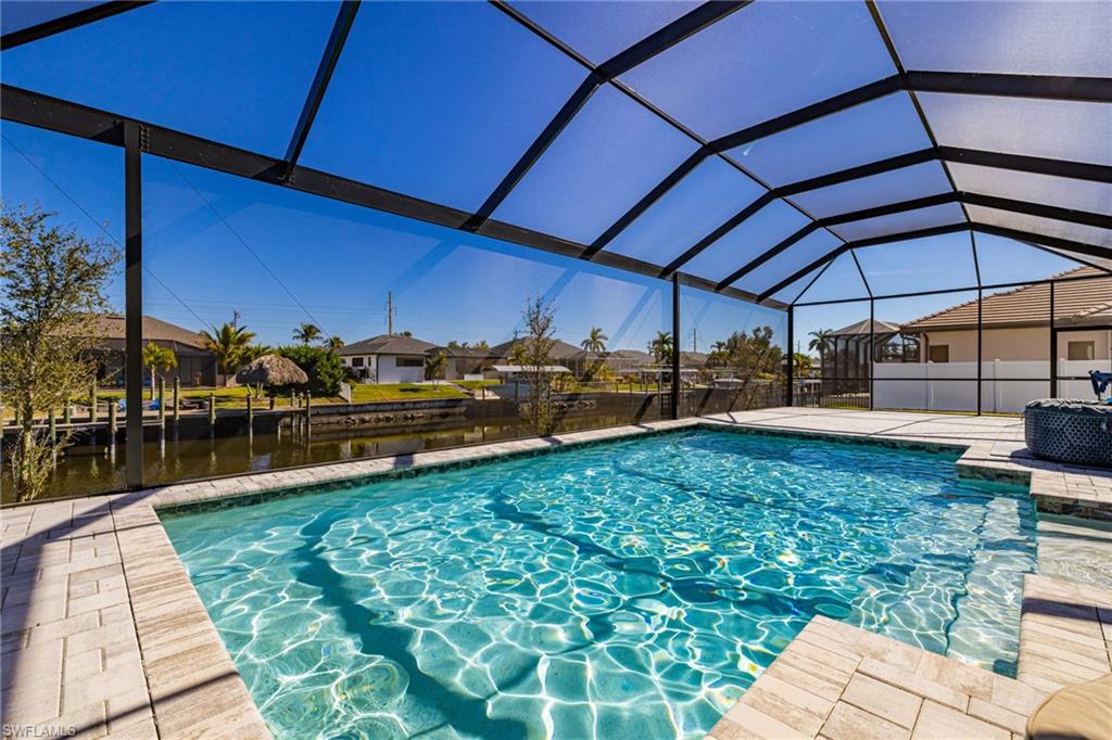 View of pool featuring a residential view, a sunroom, and a lanai