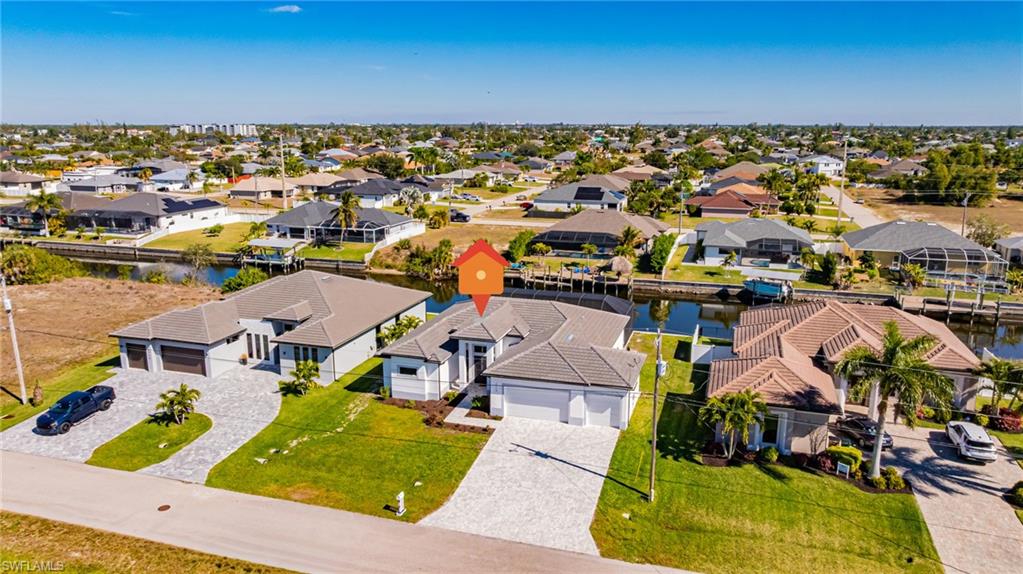 Aerial perspective of suburban area featuring a large body of water